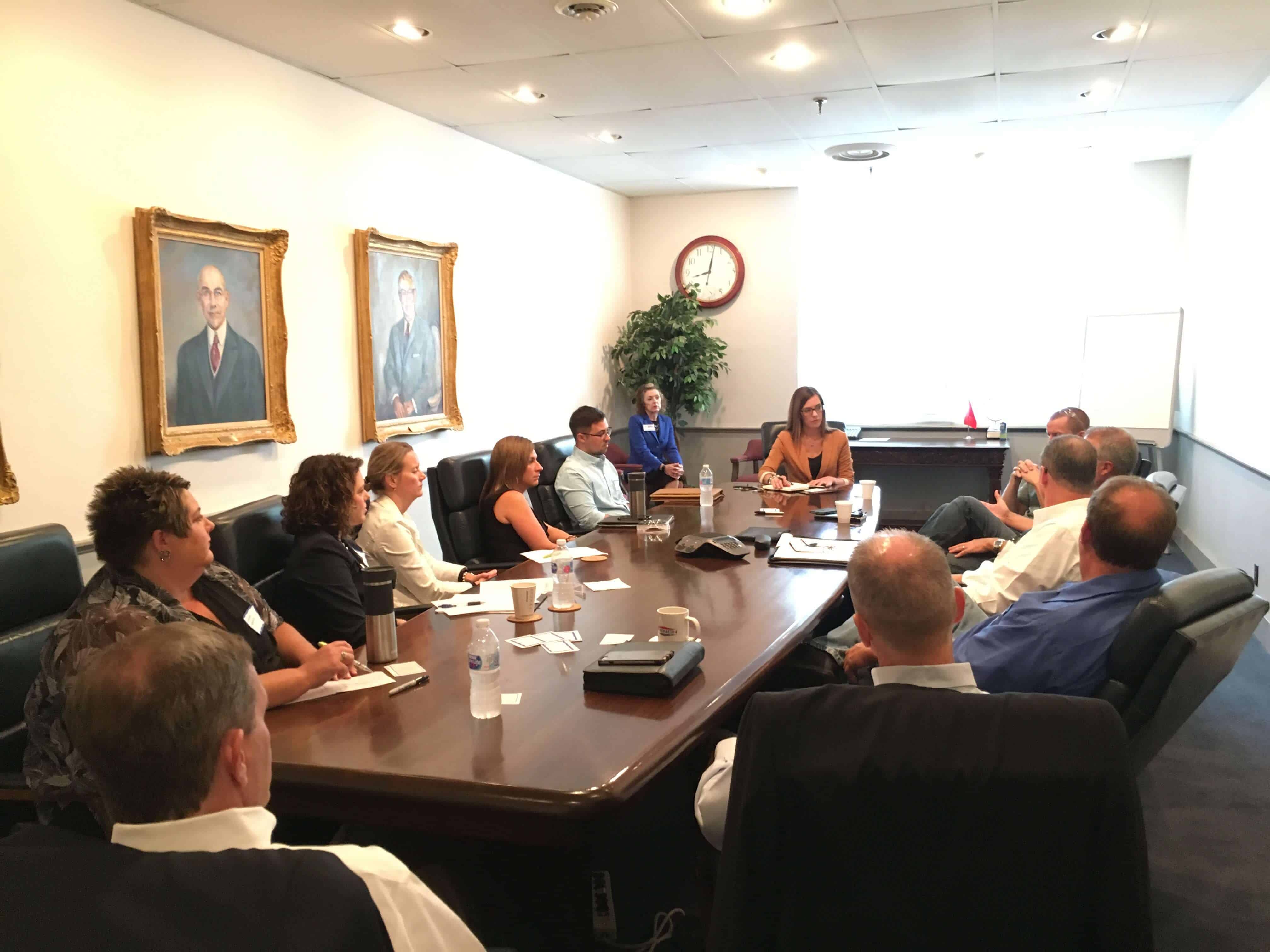 DRMA Government Relations Committee Meet Up - Group Sitting Around Table Discussing